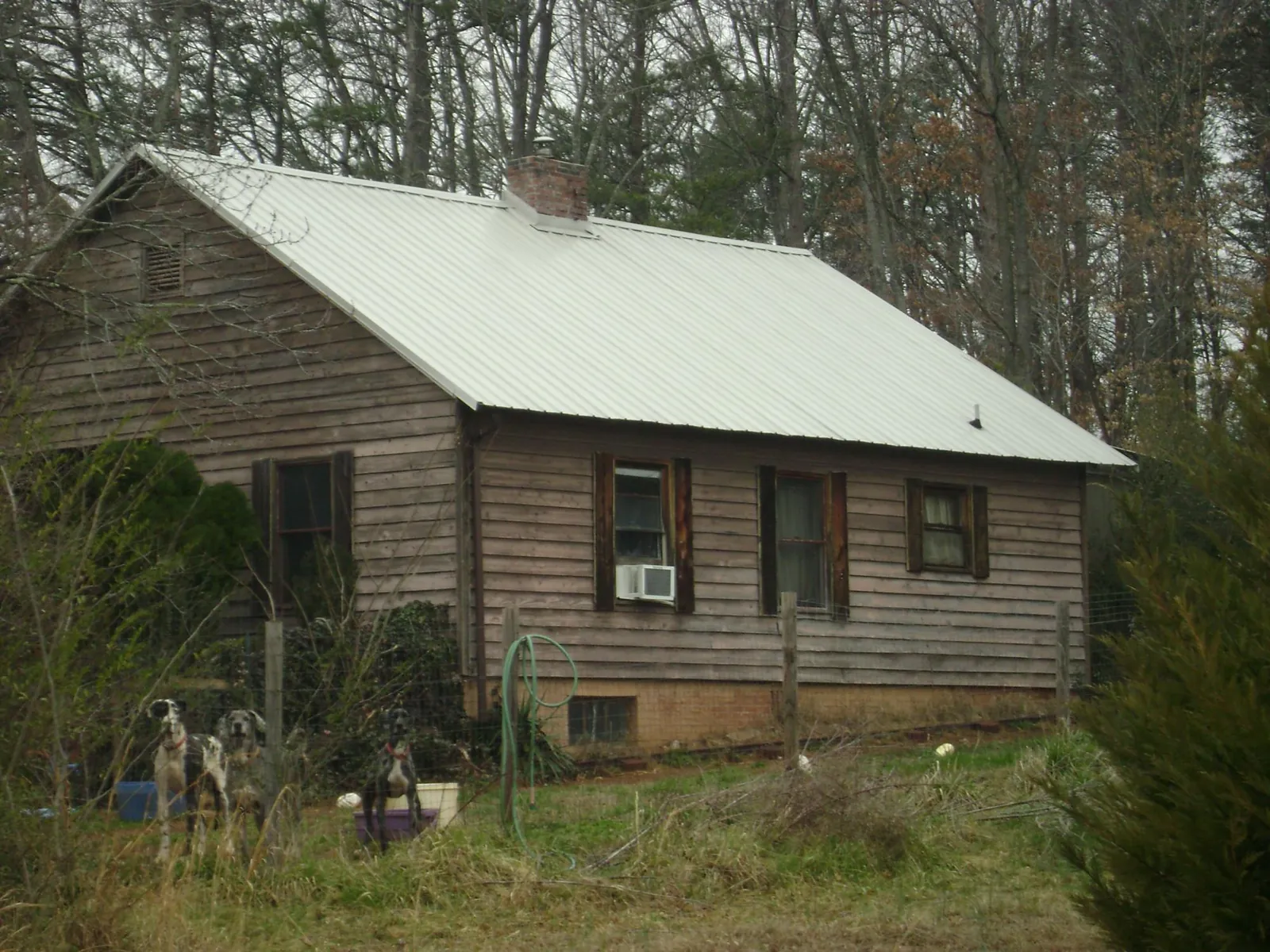 White metal roof on an old wood sided farmhouse, from a Metal Roof Installation job in Sharon Center